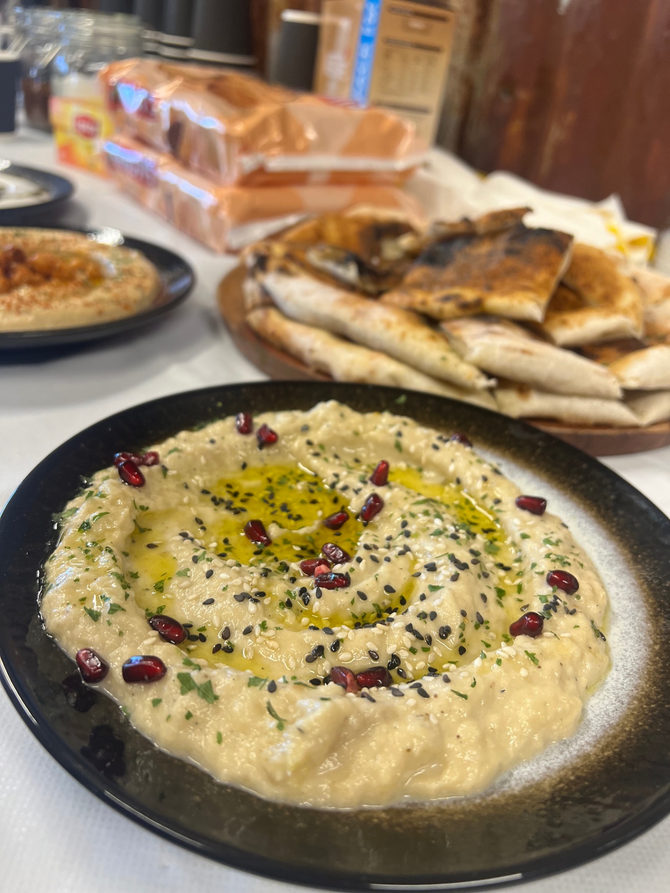 Hummus plate with pita and pomegranate