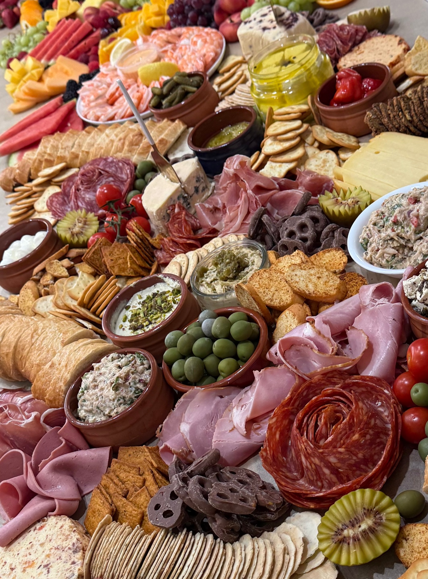 Elevated charcuterie and fruit grazing board spread