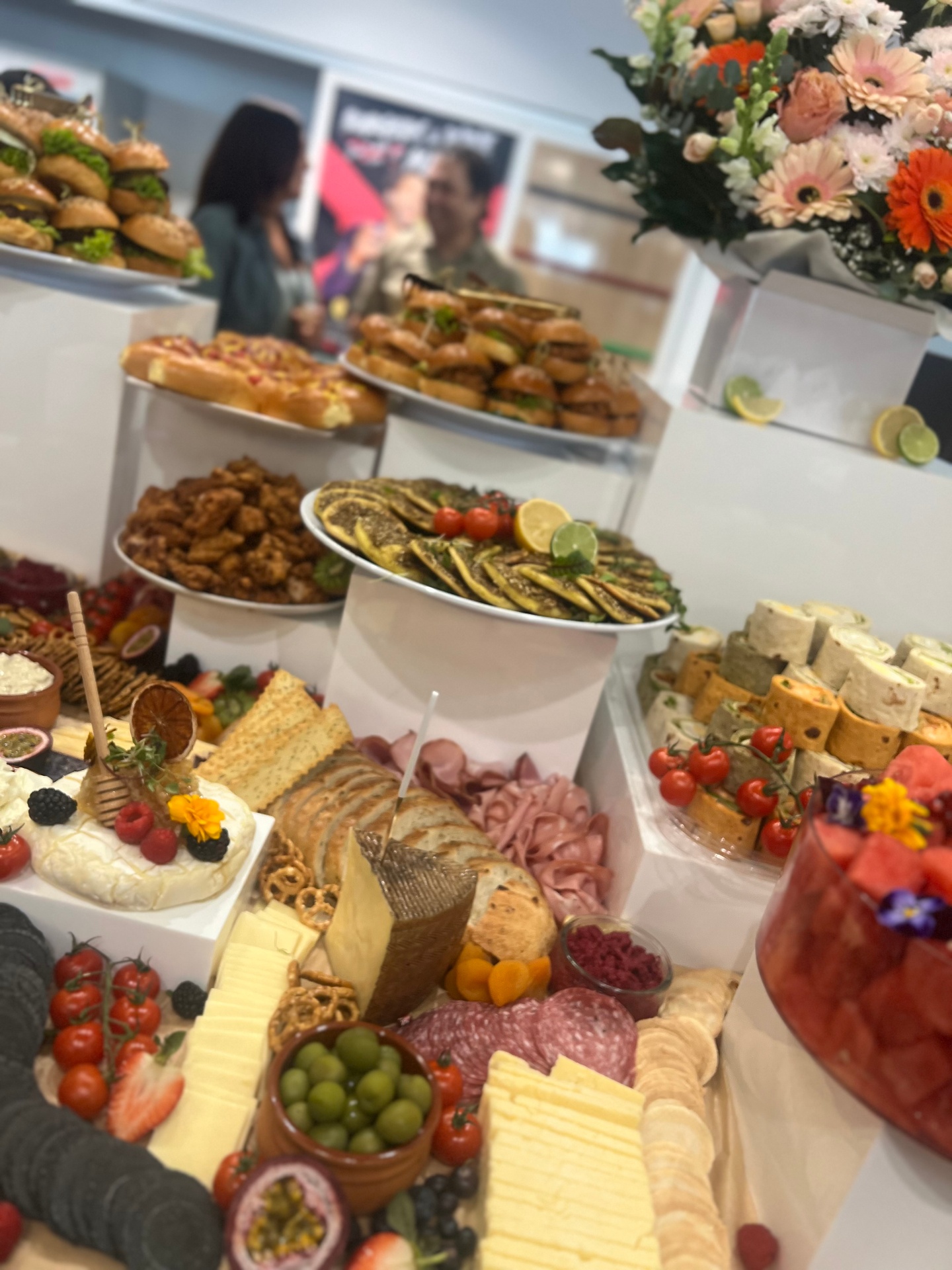 Buffet spread with cheeses, charcuterie and florals