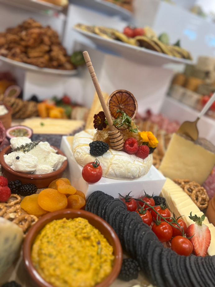 Styled grazing platter with baked brie, berries, crackers and cheese
