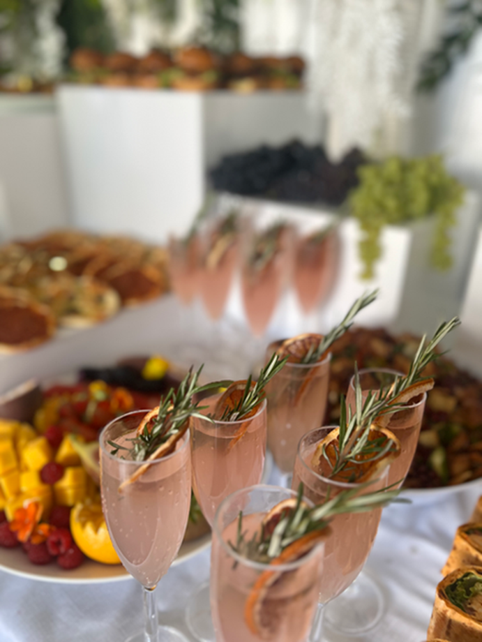 Rosé cocktails in front of a styled grazing table