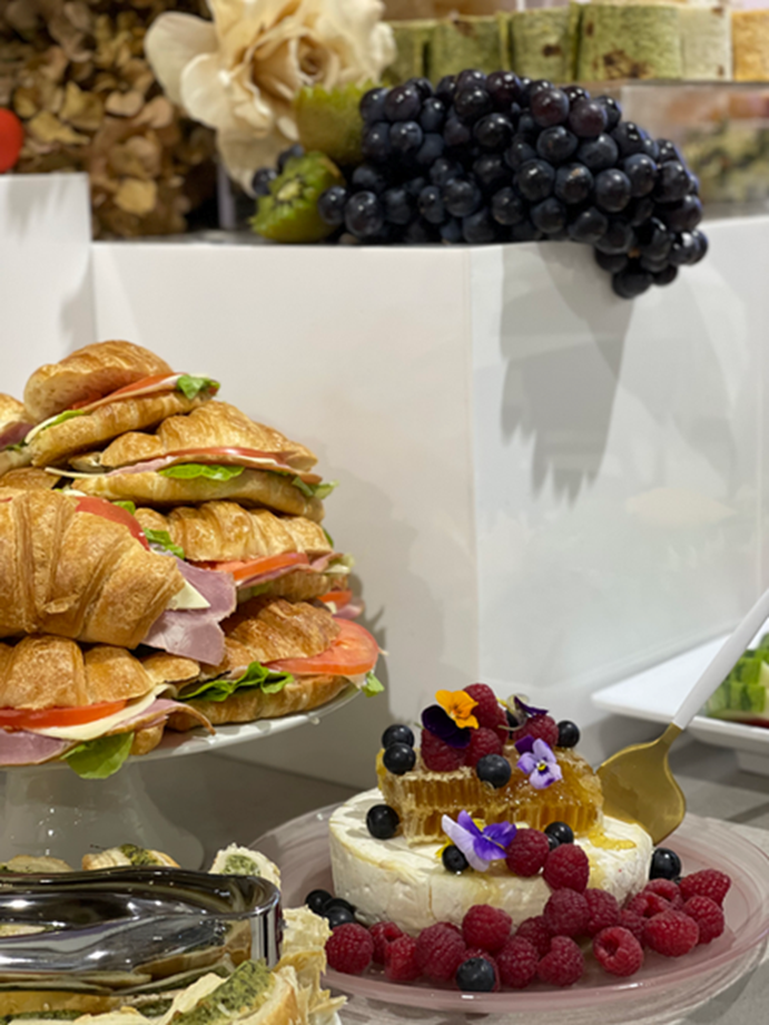 Croissants, soft cheese, berries and grapes styled on a grazing table